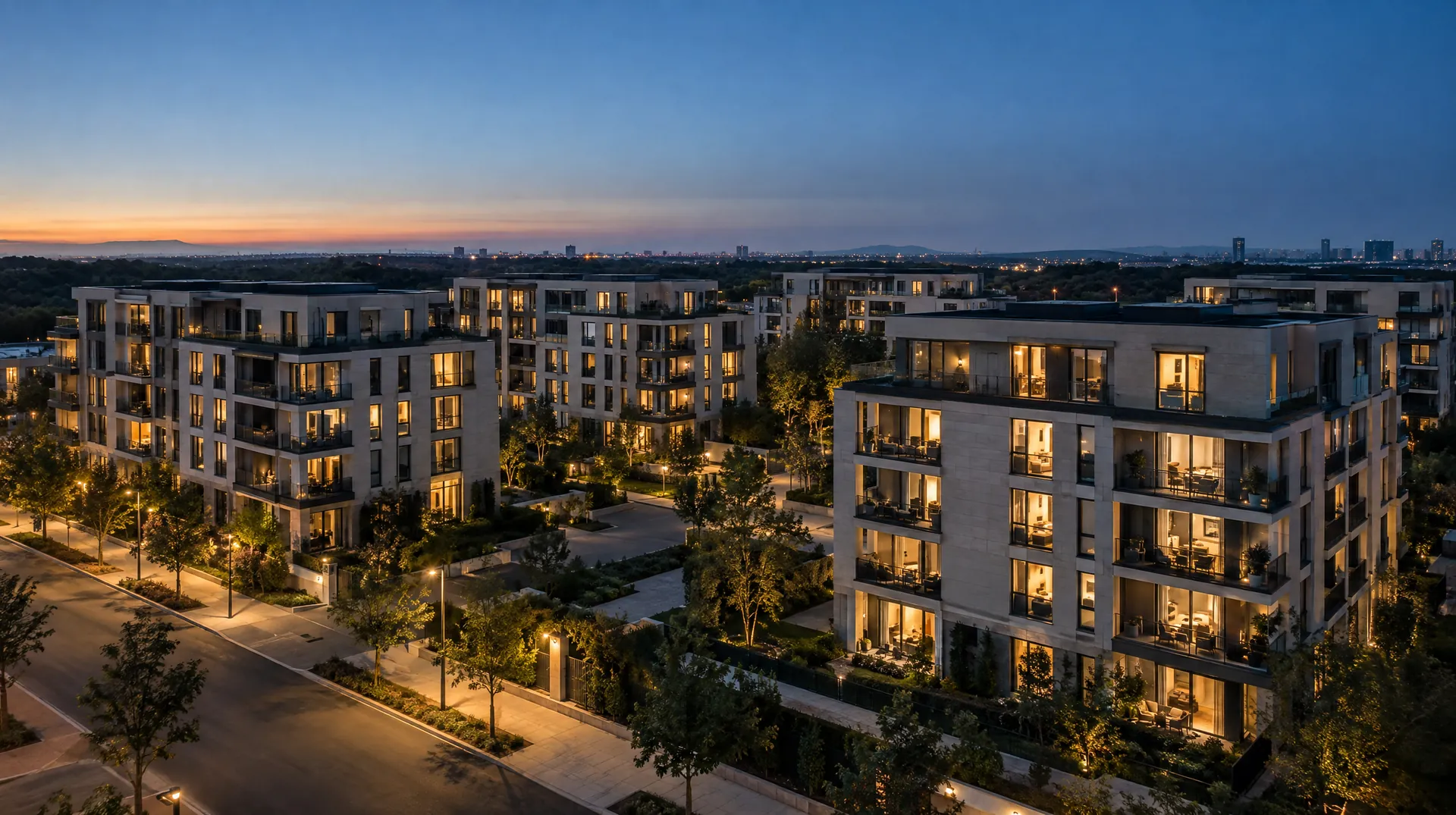 Several modern apartment buildings at dusk with many windows lit